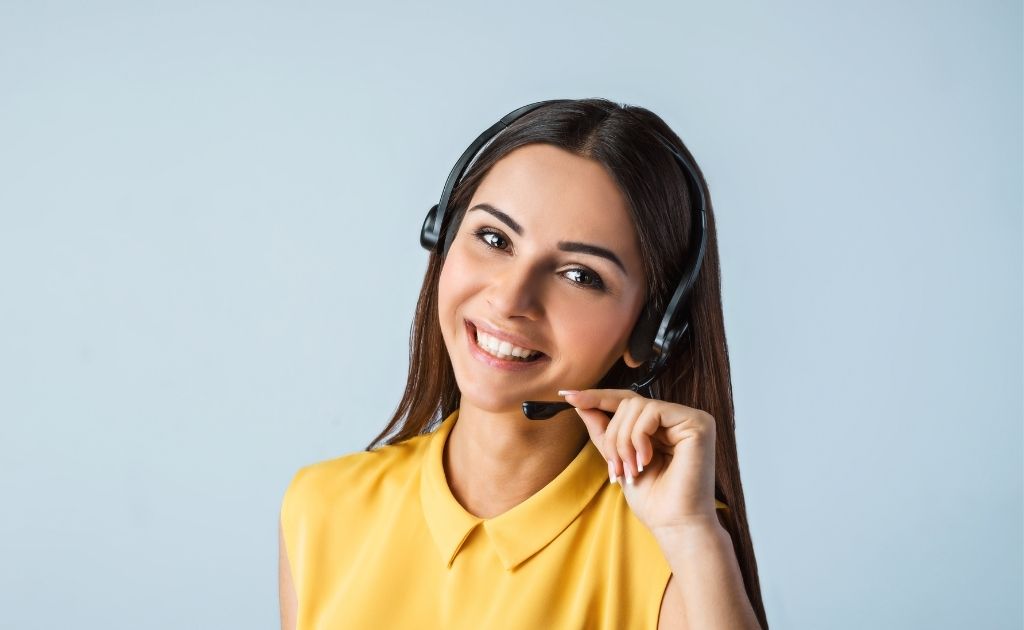 Woman working as a virtual receptionist, dealing with an angry caller, using a headset