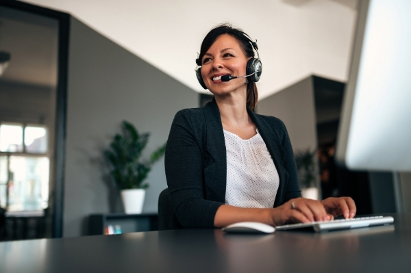 Woman smiling on call for inbound call centre agency
