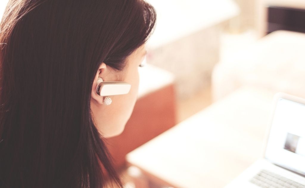 Woman answering calls on behalf of her customers, who use virtual assistants services.