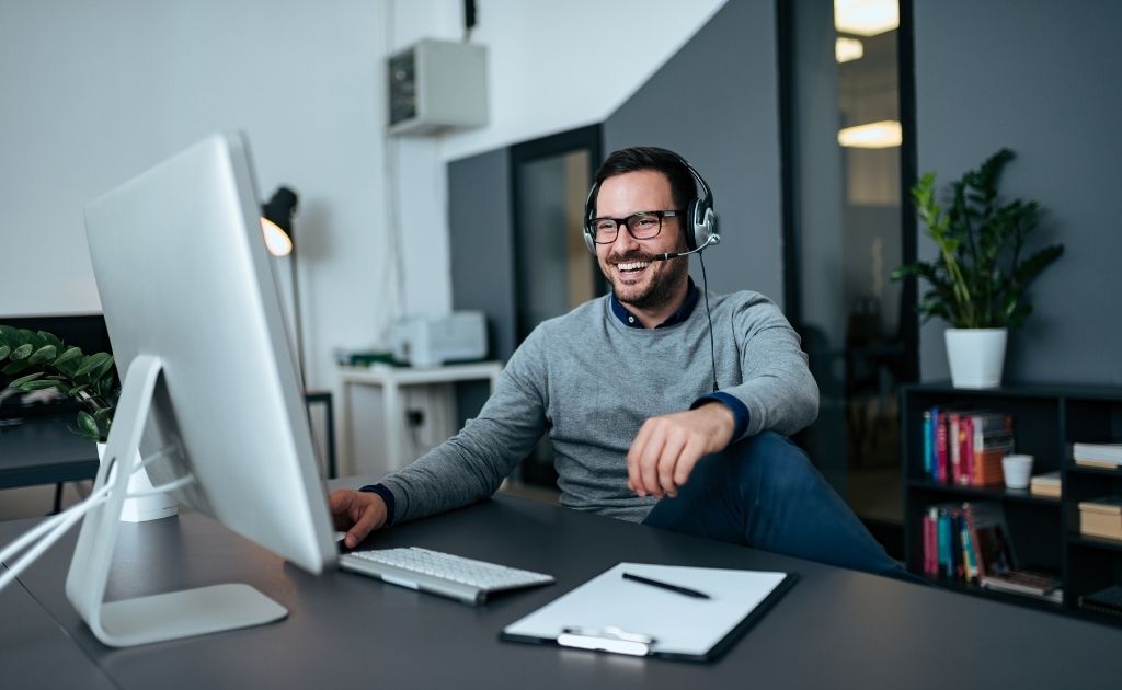 Man with headset responding as small business live answering agent