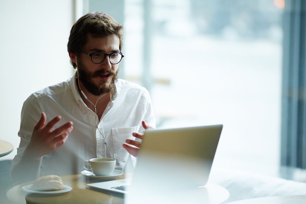 Person on video call remotely onboarding a new client