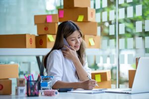 Smiling receptionist on call to customer using Appointment Scheduling Service