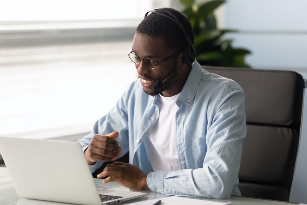 Smiling man acting as virtual receptionist at answering service for small business