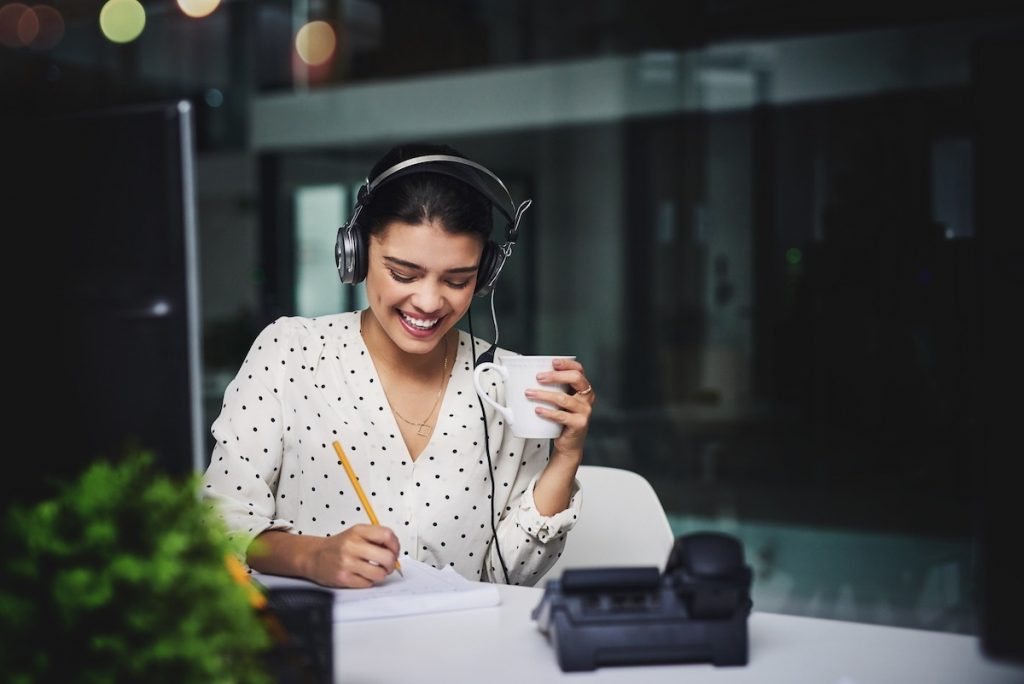 Female virtual receptionist taking notes while forwarding call