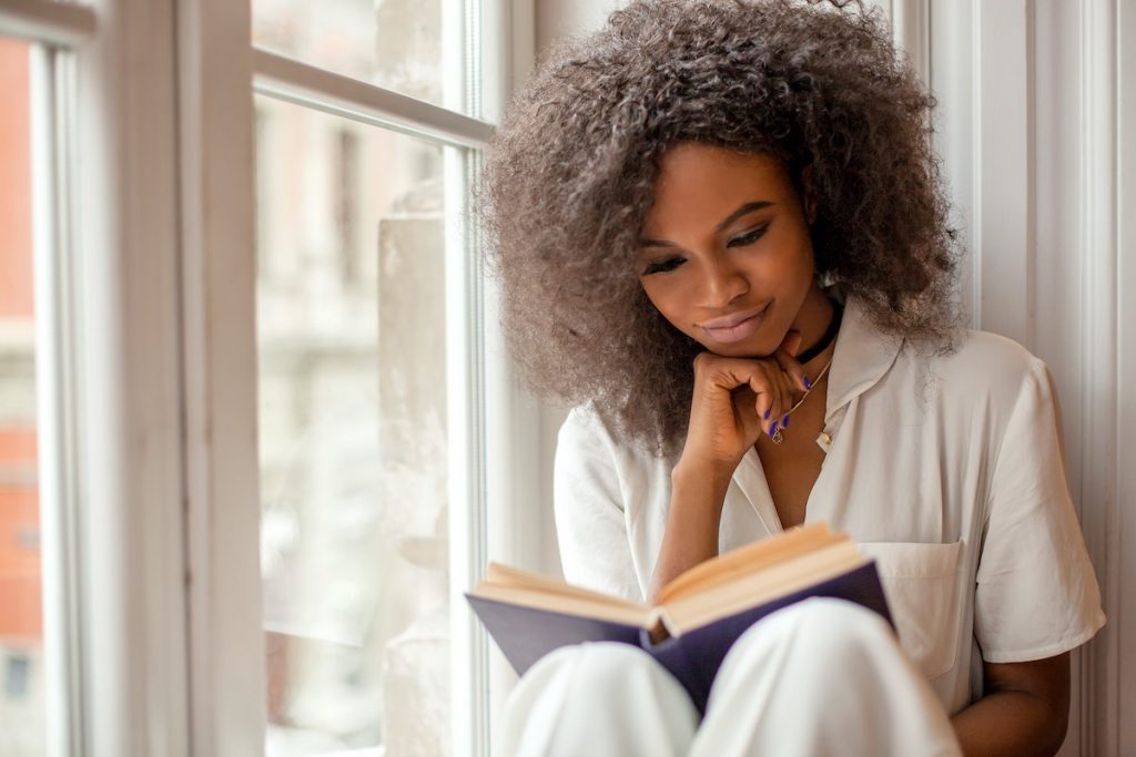 Woman reading book alone as part of employee book club