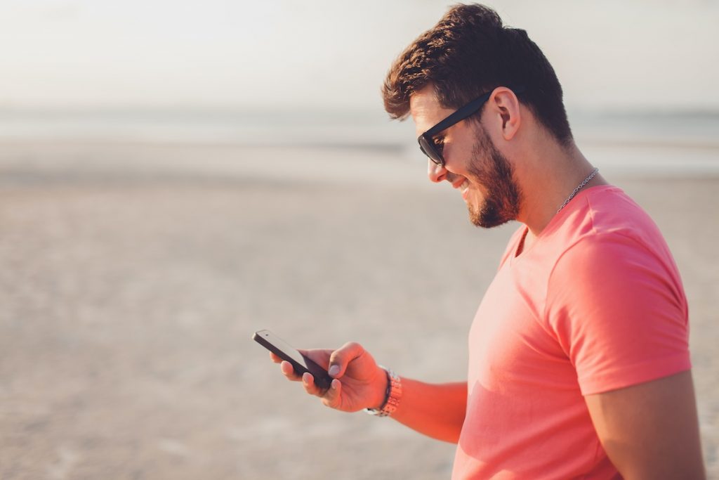 Man talking on phone to virtual receptionist via Facebook Messenger live chat integration