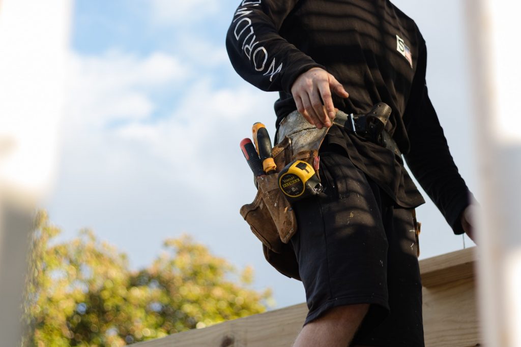 Builder with tool belt outdoors