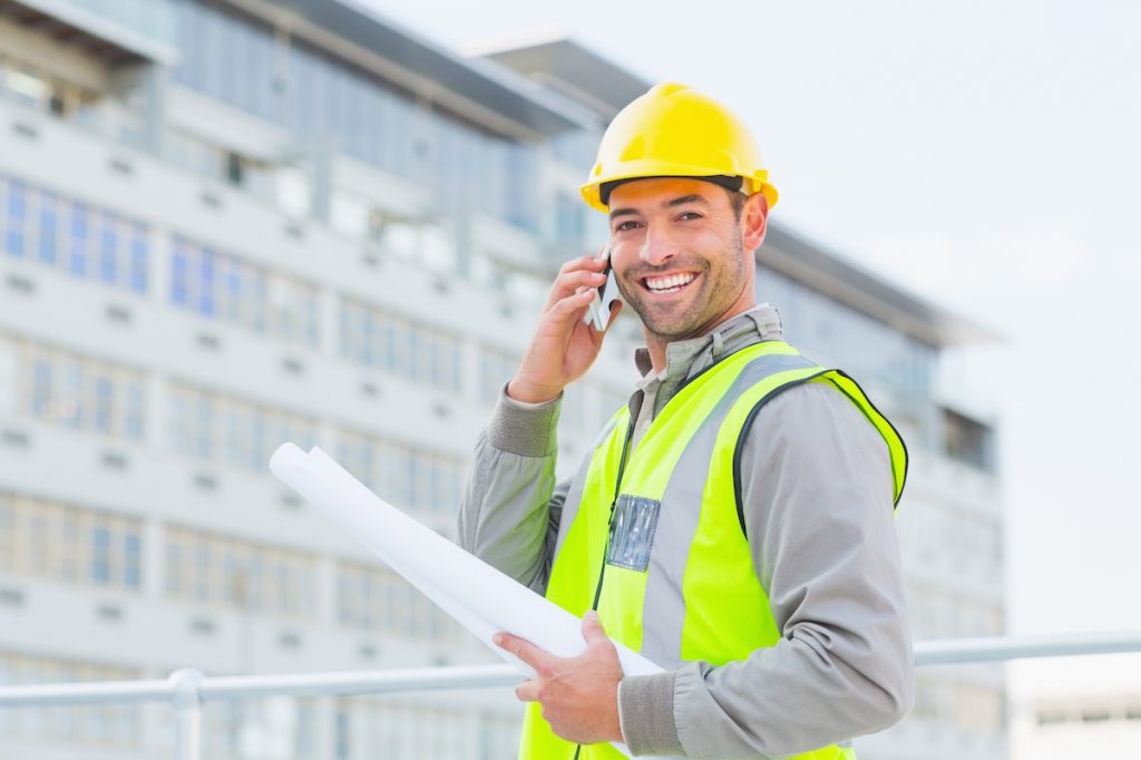 Smiling contractor talking to receptionist via contractor answering service