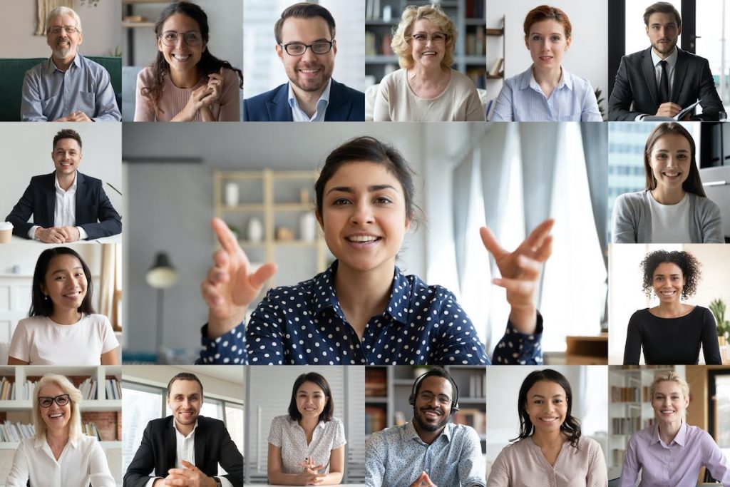 Woman hosting video call with multiple colleagues in individual chat windows