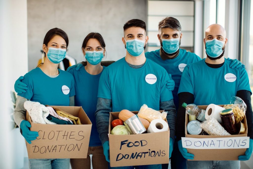 Team sorting food donations as part of business volunteer program