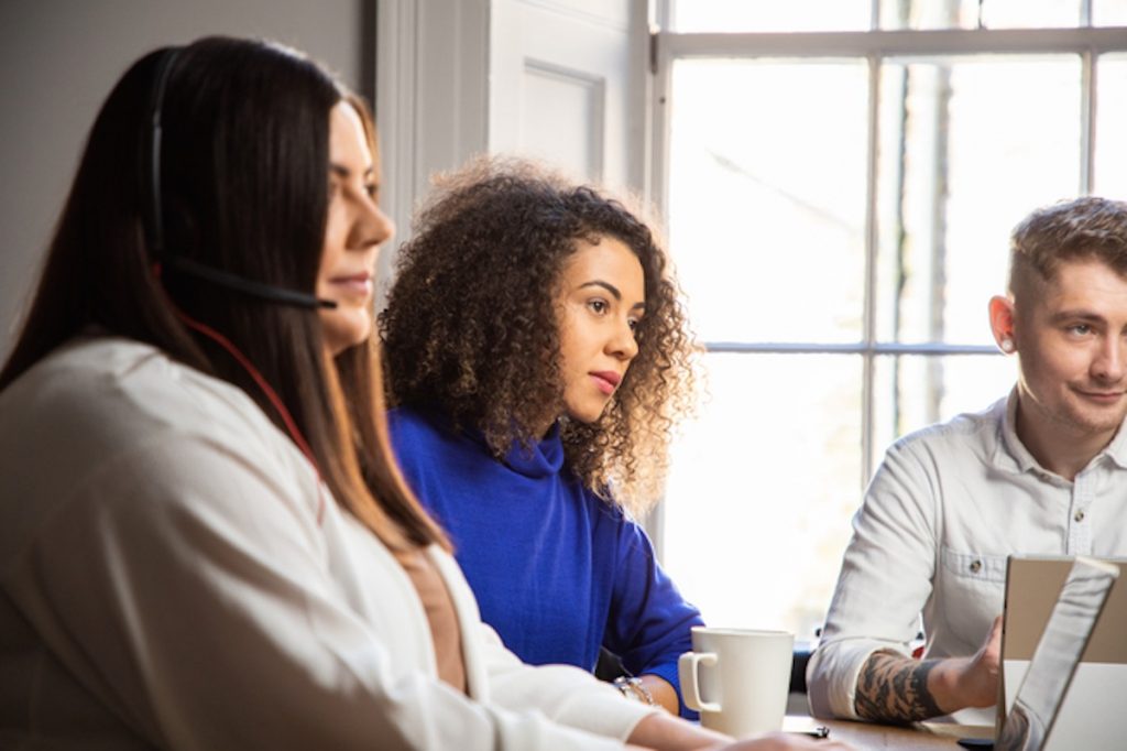 Some of the AnswerConnect team collaborating in-office