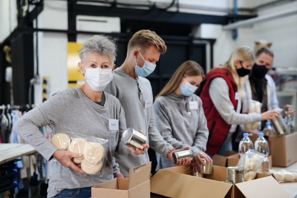 Business team packing food boxes for employee volunteer program