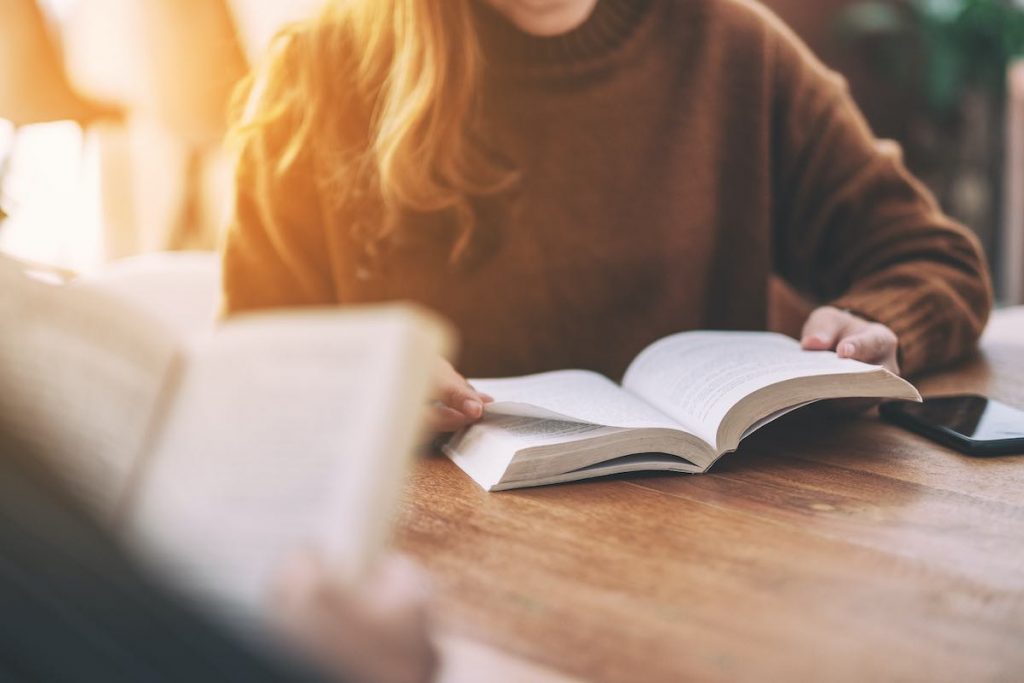 Group reading book outside for employee book club