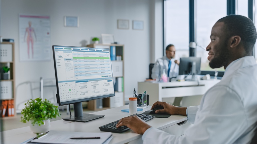 Man typing on computer in office searching using hyperlocal SEO