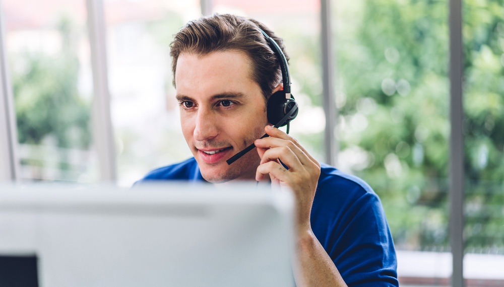 Agent with headset answering calls for telephone answering service