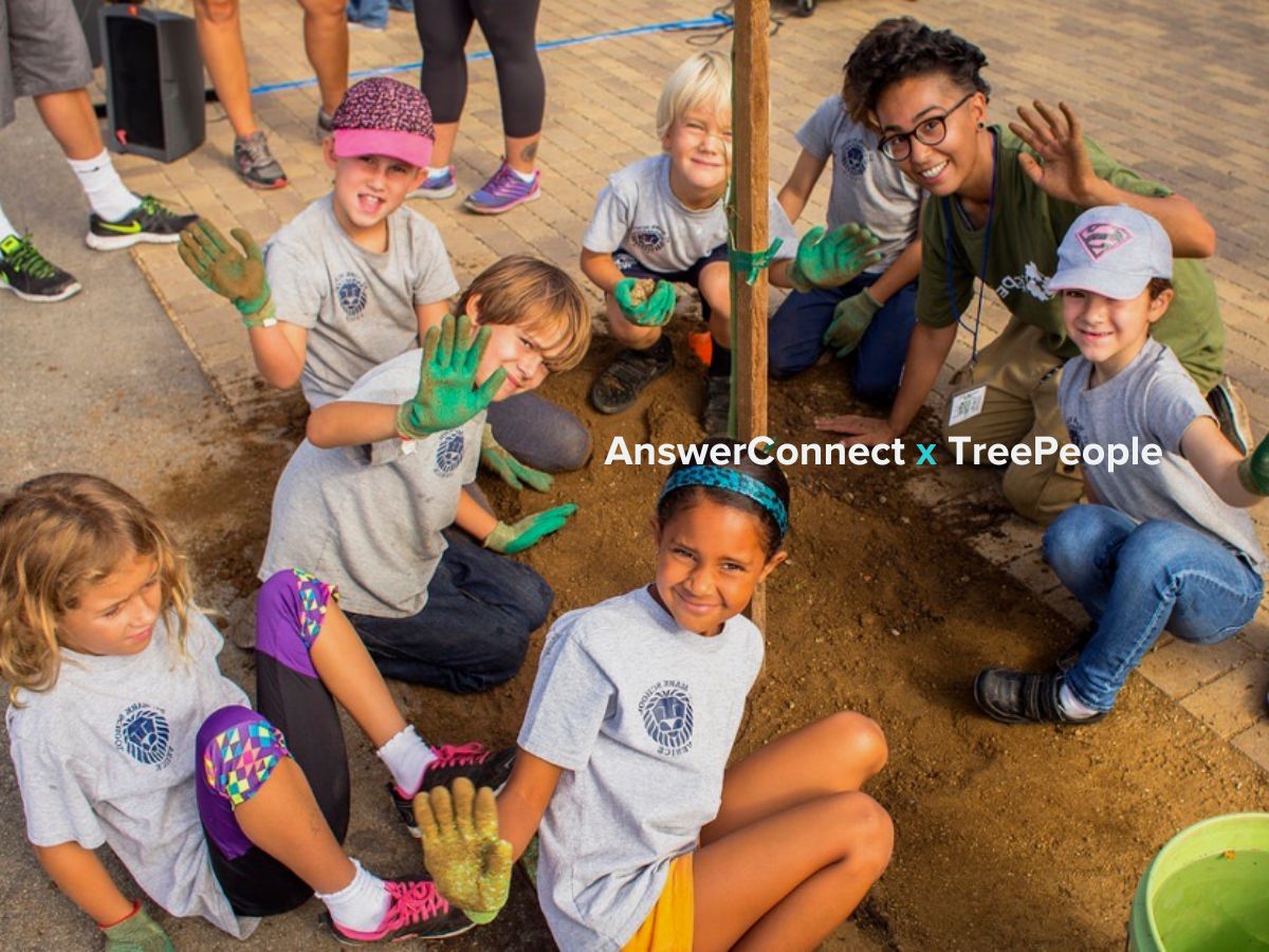 Feature image of kids planting a tree in dirt with volunteer