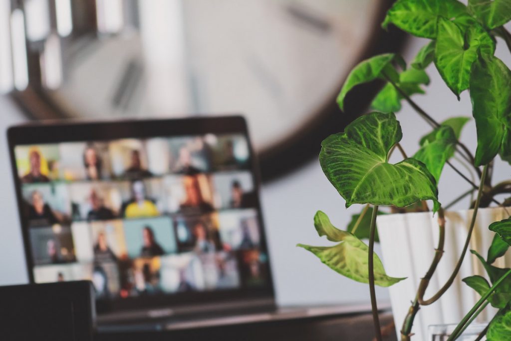 Person on video call working from home to promote sustainable business practices