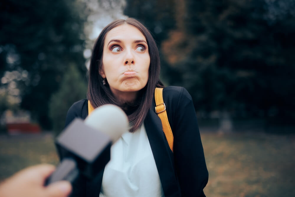 Woman looking confused by interviewer question about local commerce