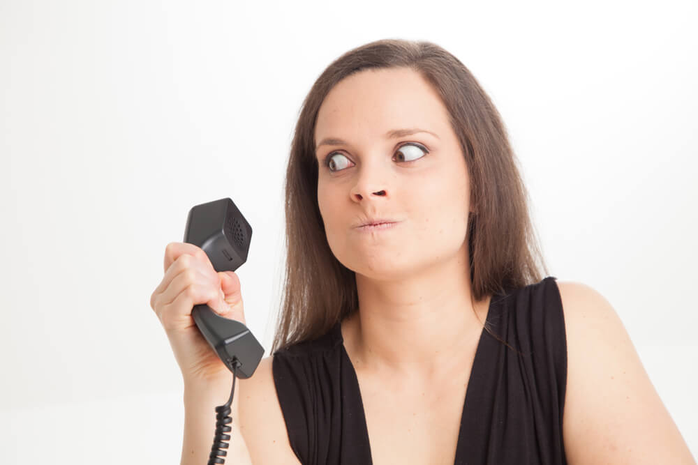 Woman looking frustrated at phone