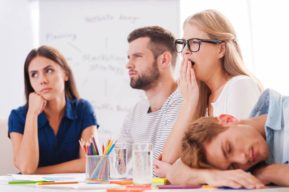 Workers in a meeting looking bored