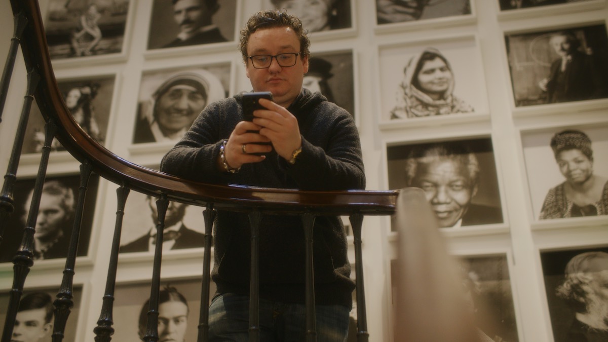 Man looking at smartphone waiting for business to respond