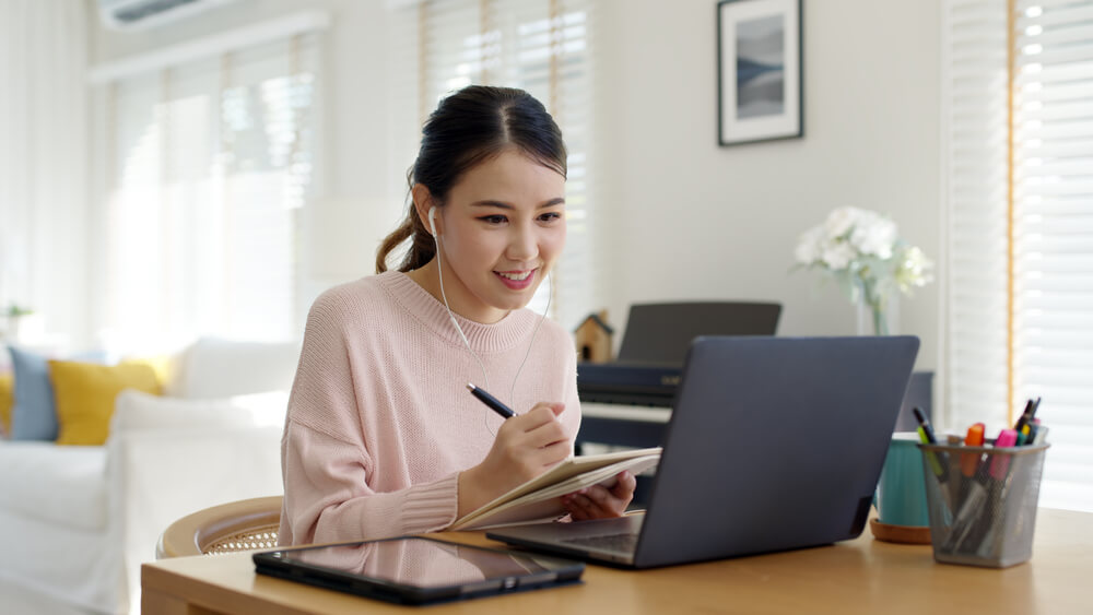 Smiling virtual receptionist on laptop in virtual office