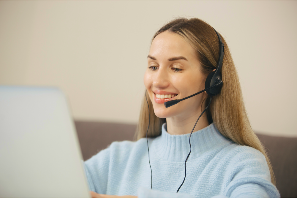 A happy receptionist wearing headphones