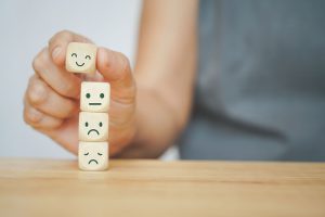 Blocks stacked on top of each other with faces representing customer satisfaction