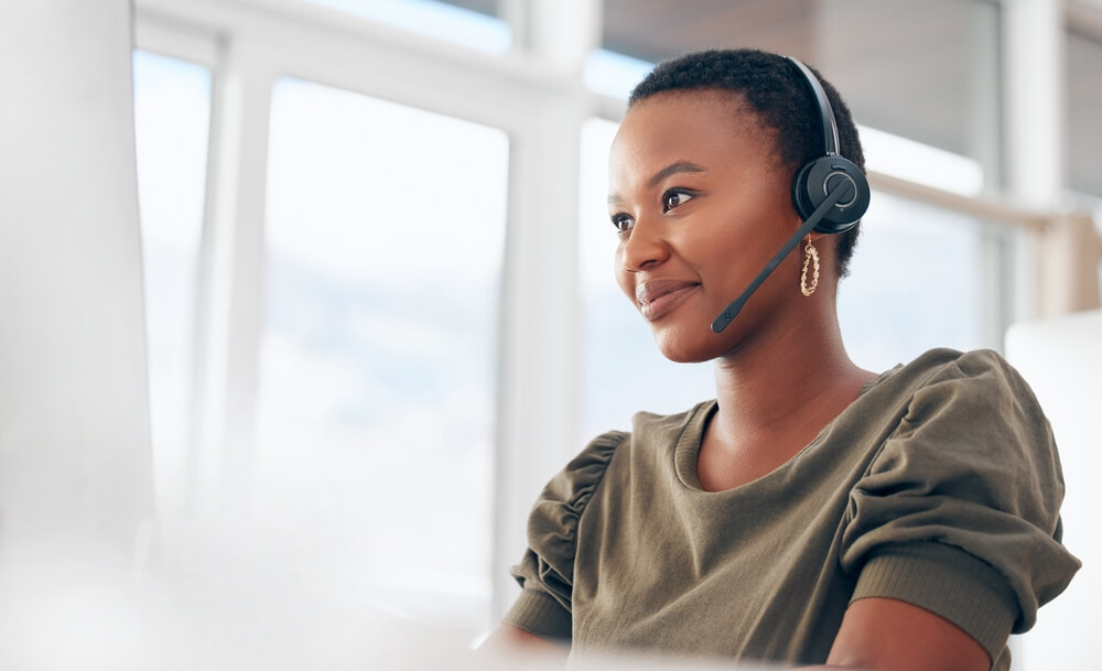 Smiling receptionist answering calls for Outsourced Customer Service provider