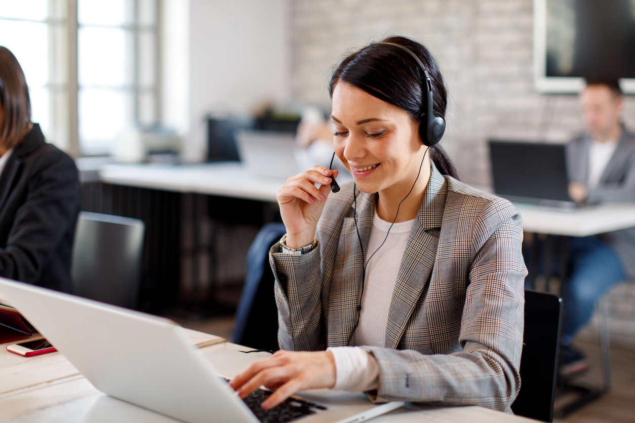 women receptionist wearing headset and working