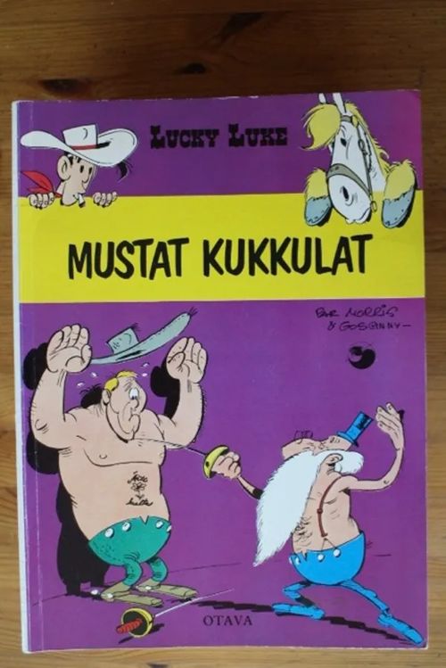 Lucky Luke - Mustat kukkulat | Antikvaarinen Kirjakauppa Tessi | Osta Antikvaarista - Kirjakauppa verkossa