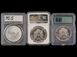 THREE VINTAGE AMERICAN SILVER EAGLE COINS GRADED