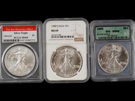 THREE VINTAGE AMERICAN SILVER EAGLE COINS GRADED