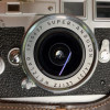 A VINTAGE LEICA M3 CAMERA WITH A CASE PIC-3