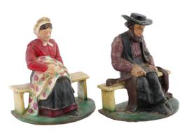 ANTIQUE CAST IRON AMISH COUPLE DOOR STOPPERS