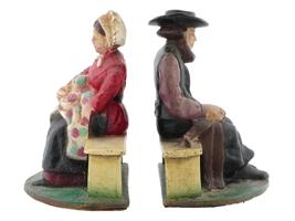 ANTIQUE CAST IRON AMISH COUPLE DOOR STOPPERS