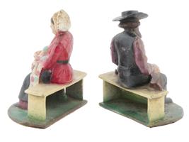 ANTIQUE CAST IRON AMISH COUPLE DOOR STOPPERS