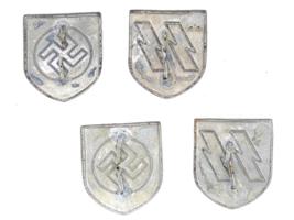 GROUP OF 4 GERMAN WWII SHIELDS FOR SS PITH HELMET