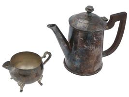 ANTIQUE SILVER PLATED LIDDED TEAPOT AND FOOTED CREAMER