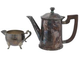 ANTIQUE SILVER PLATED LIDDED TEAPOT AND FOOTED CREAMER