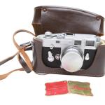 A VINTAGE LEICA M3 CAMERA WITH A CASE PIC-0