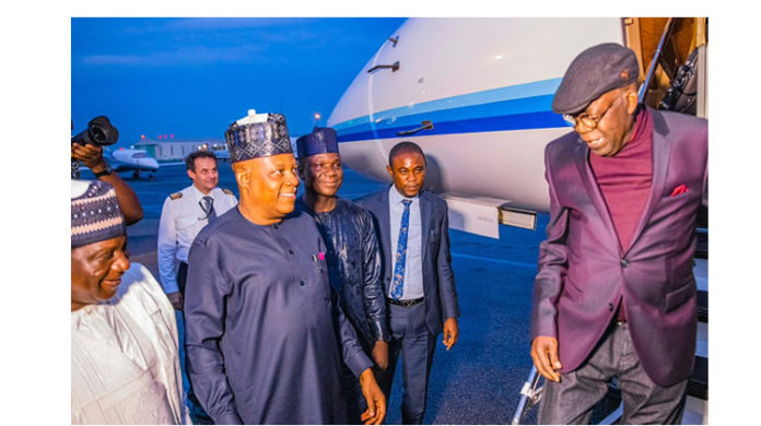 aede bola tinubu at the airport after his arrival from london