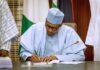 ec president muhammadu buhari signing