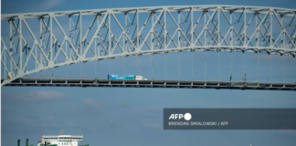 f a cargo ship passes below the francis scott key bridge while leaving the port of baltimore october in baltimore maryland.