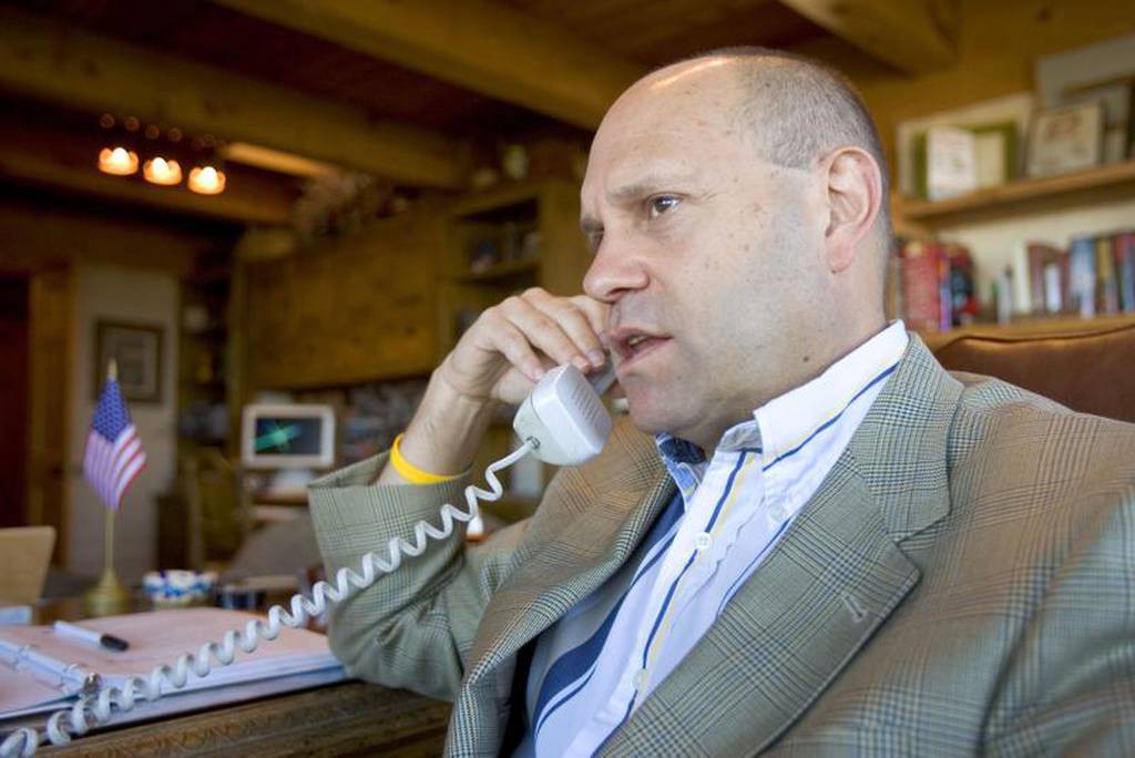 Mikey Weinstein wearing a suit jacket looking like he's on an important phone call.