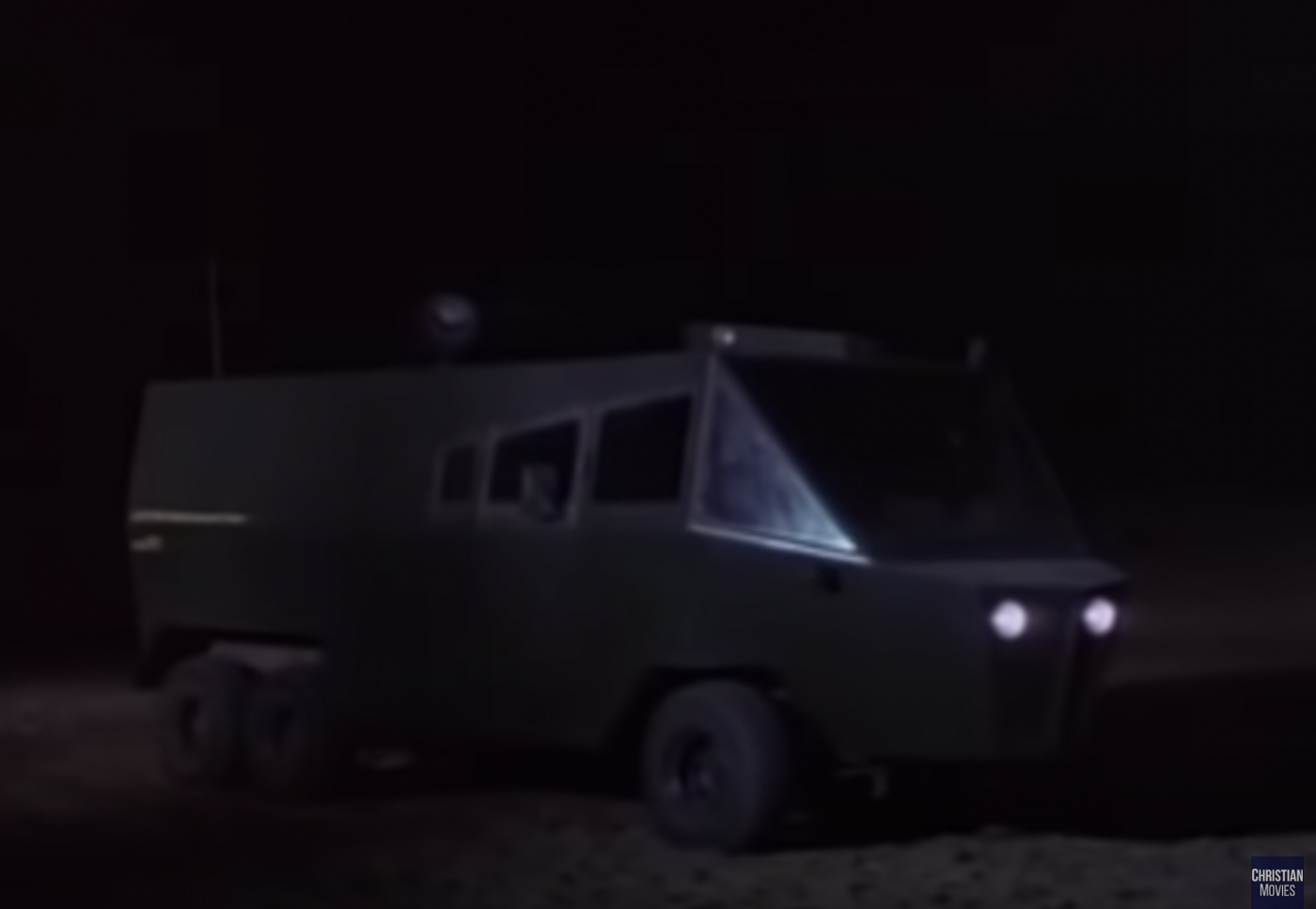 The RV with its lights on at night.