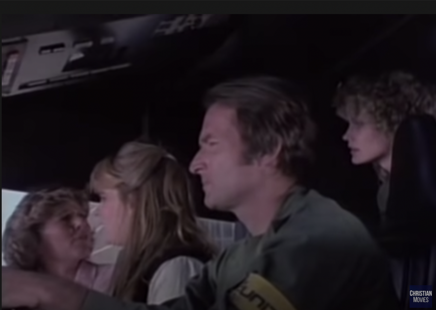 David driving, while Linda and Jodi—a woman in her early 40s with curly blonde hair and a teenage girl with wavy blonde hair, respectively—sit in the front and Connie has been relegated to peering over David's shoulder.