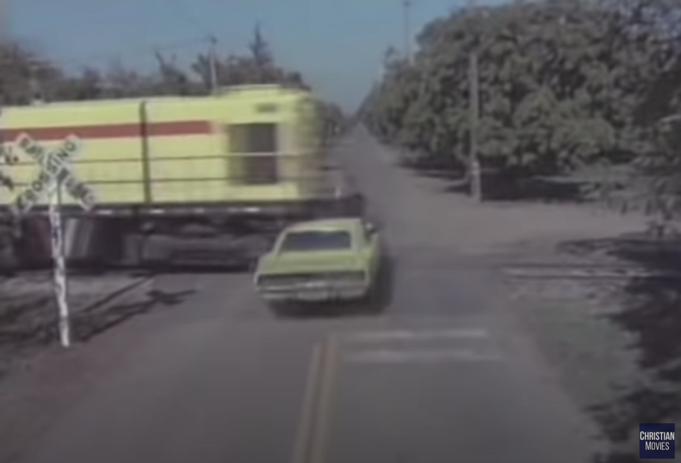 A yellow car about to collide with a yellow train at a crossing.