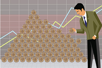 Businessman arranging money to make a money pyramid