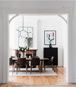 Rectangular dining table with chairs on a rug with a black sideboard